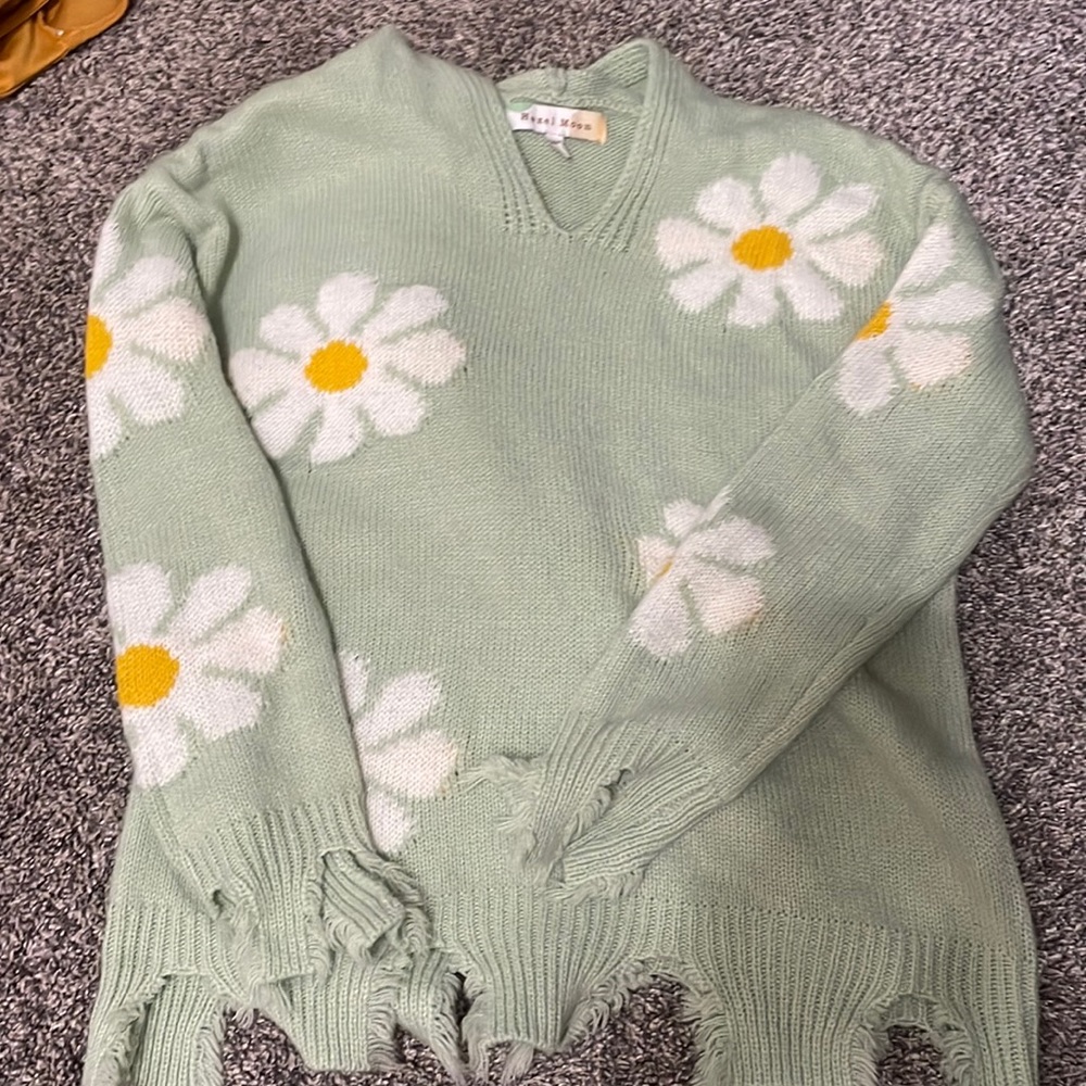 Green sweater with flowers snd and a hoodie